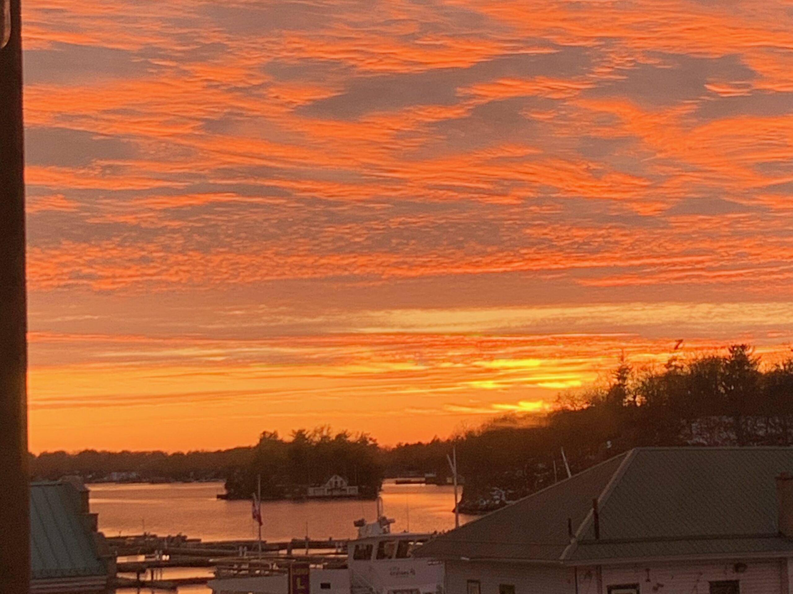 Vivid orange and yellow sunset over an island.